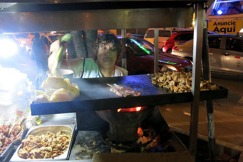 Lady selling peruvian street food in Lima by Authentic Food Quest